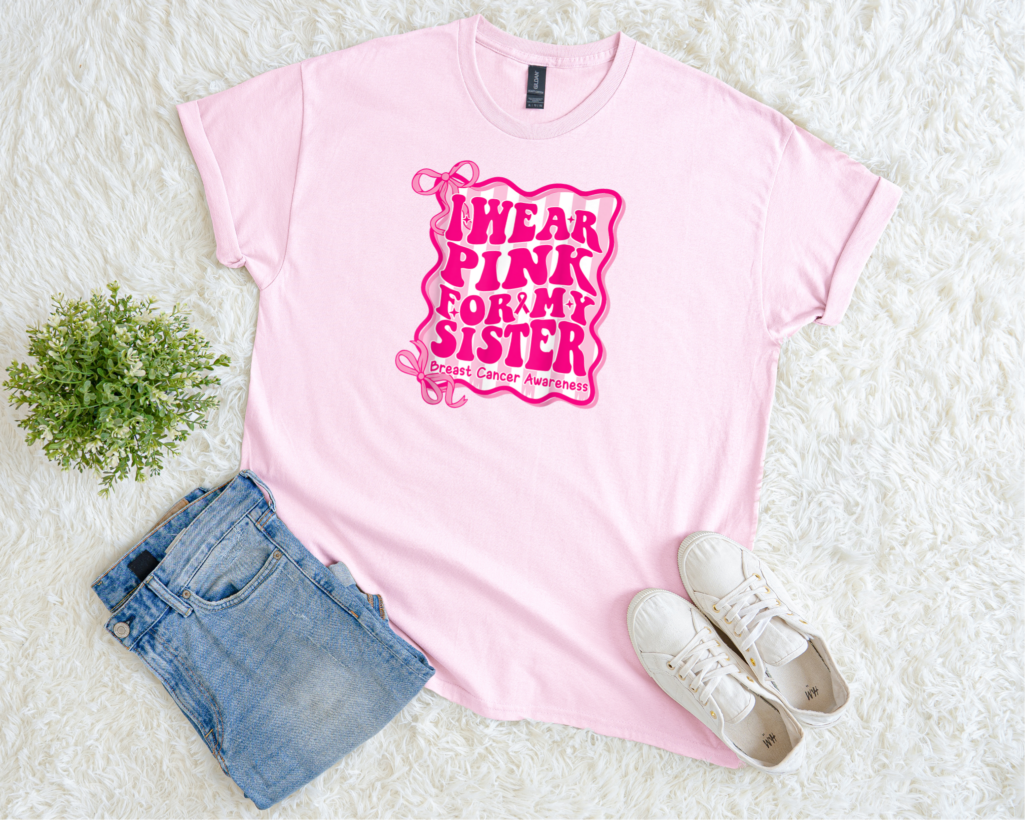 Pink t-shirt with 'I Wear Pink for My Sister' text, paired with denim shorts and white sneakers on a light background.