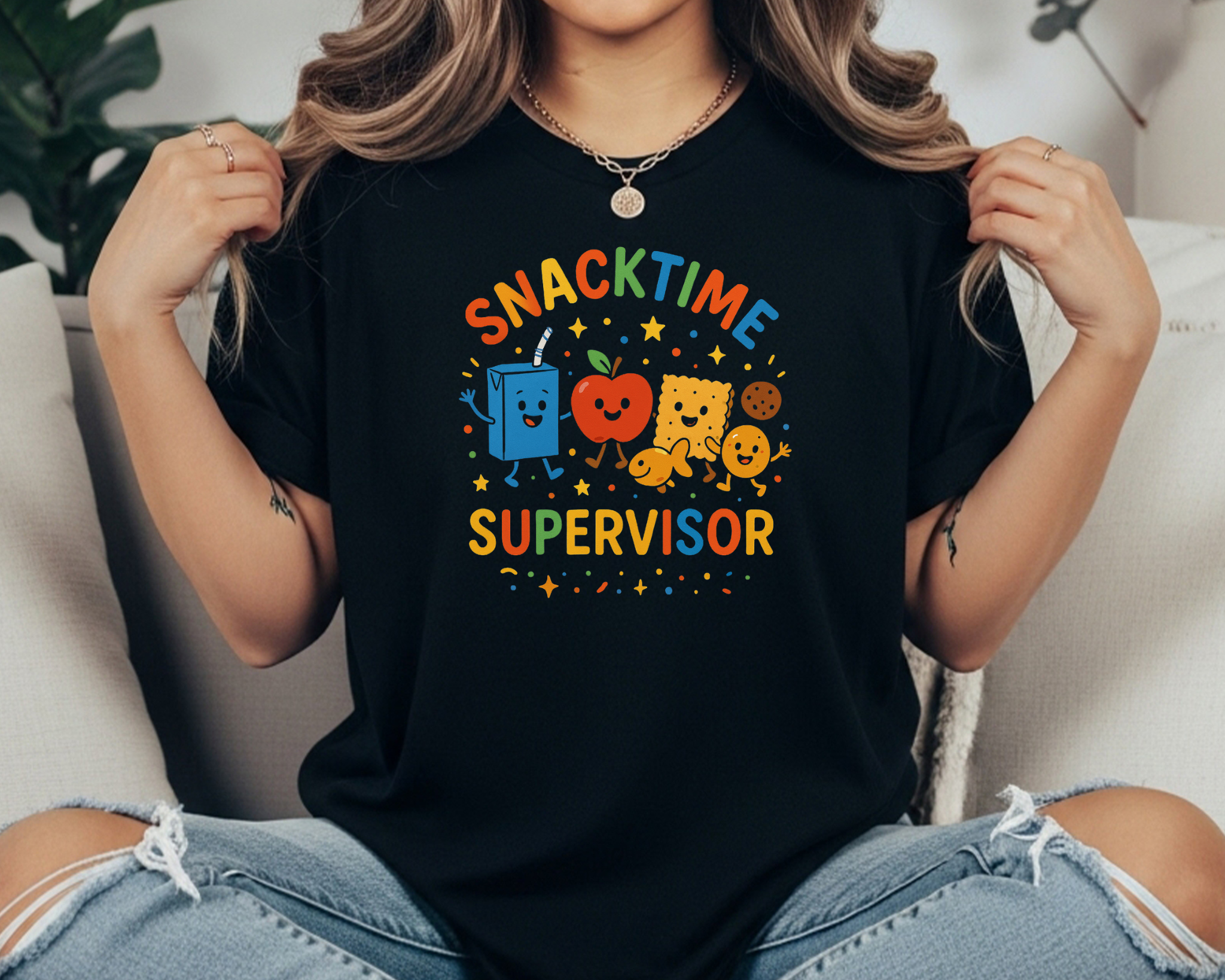 Black Comfort Colors t-shirt with “Snacktime Supervisor” in colorful text and cartoon snacks — juice box, apple, cracker, and cookie