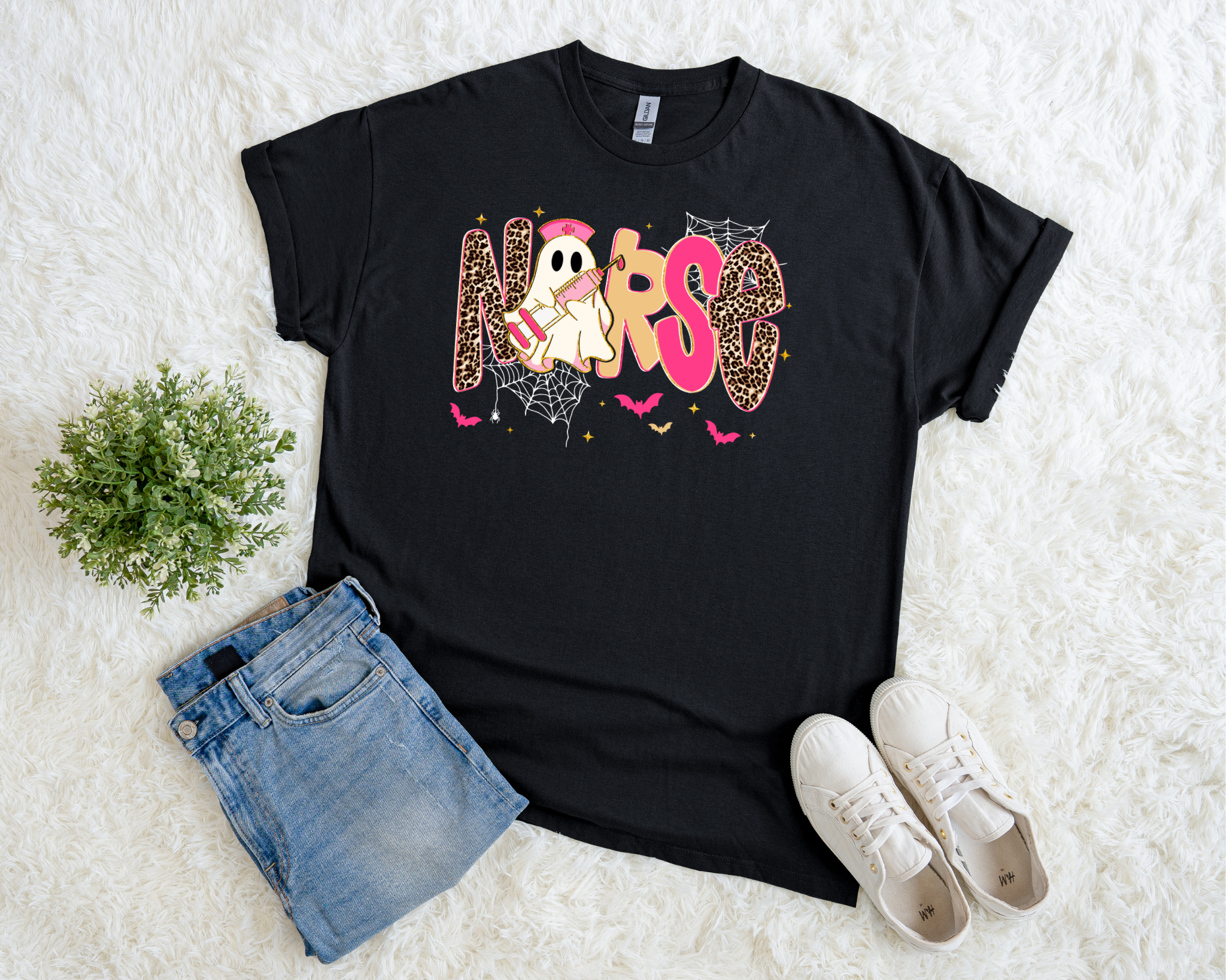 Black Halloween t-shirt with a playful “NURSE” design featuring leopard print letters, a ghost nurse, spiderwebs, and bats.