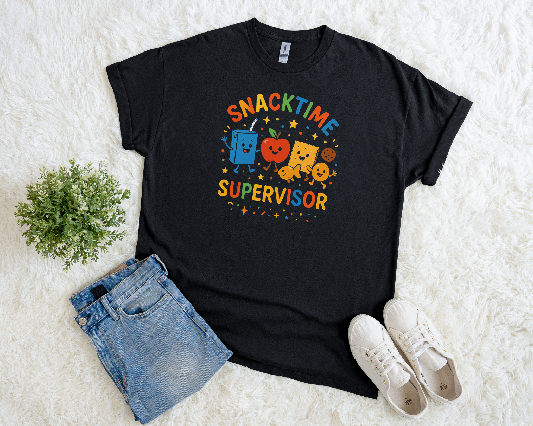 Black t-shirt with “Snacktime Supervisor” in colorful text featuring cartoon snacks — juice box, apple, cracker, and cookie.