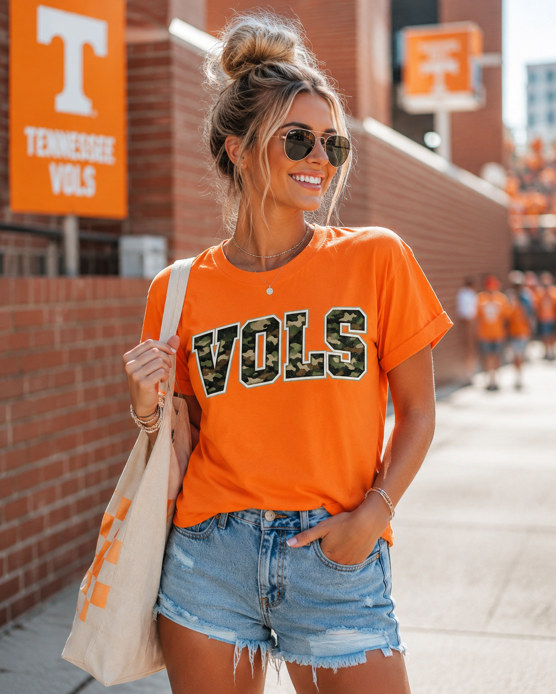 Woman wearing an orange 'VOLS' shirt with a Tennessee Volunteers logo in a casual setting.
