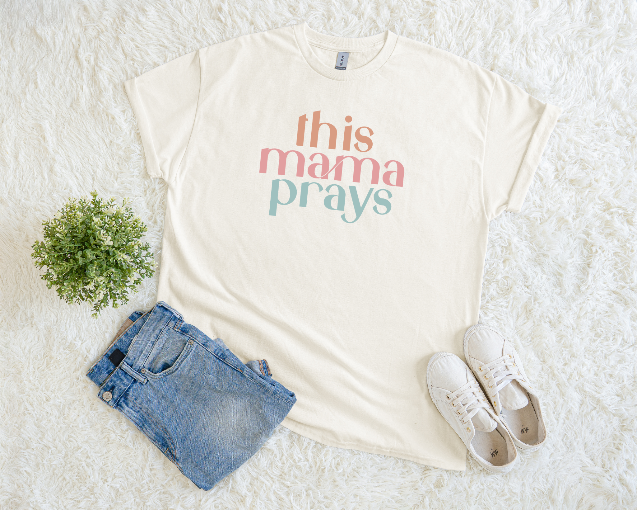 Christian t-shirt with multicolor text reading “This Mama Prays.”