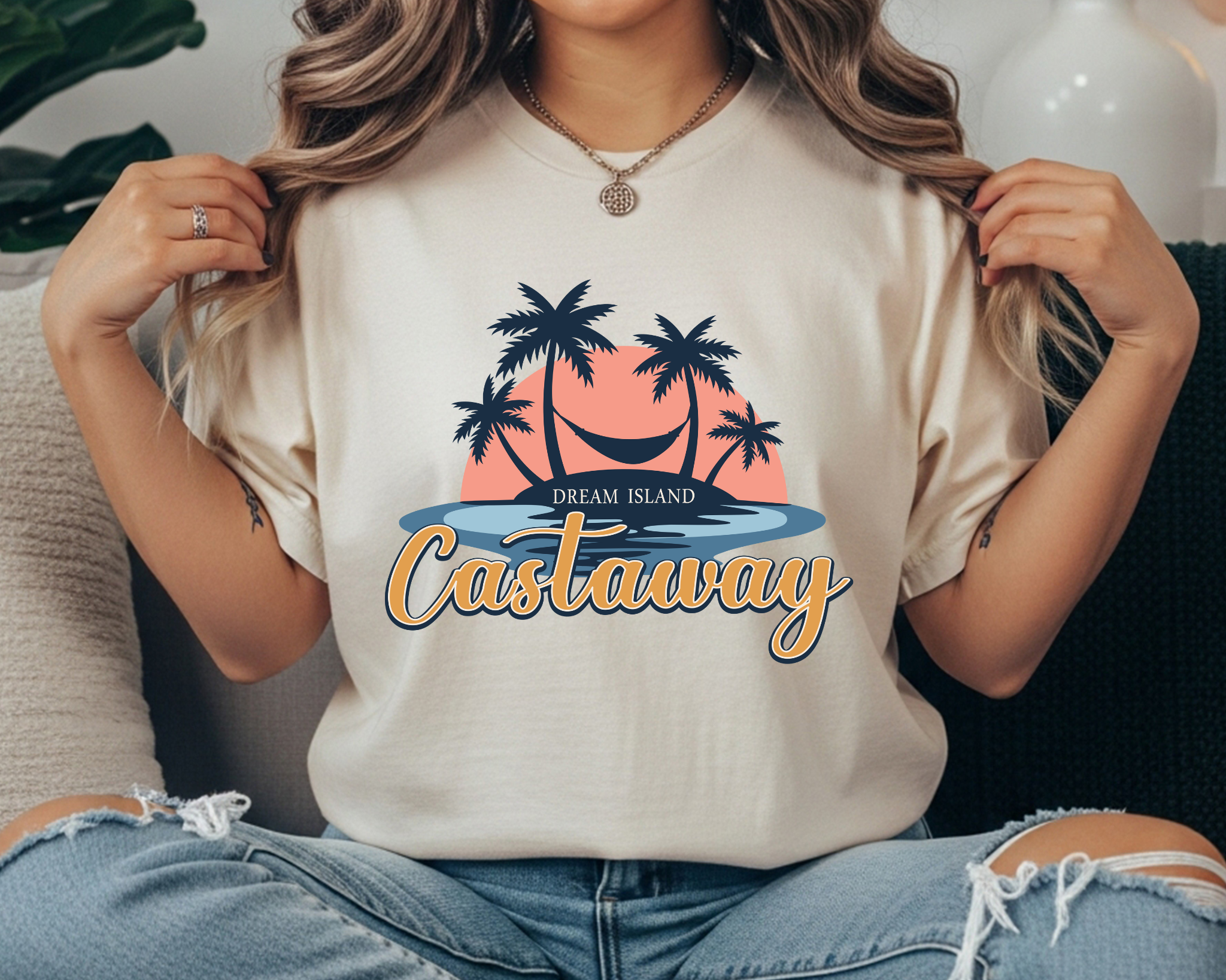 Comfort Colors t-shirt with “Dream Island Castaway” text and a retro palm tree hammock sunset graphic in navy, coral, and light blue.