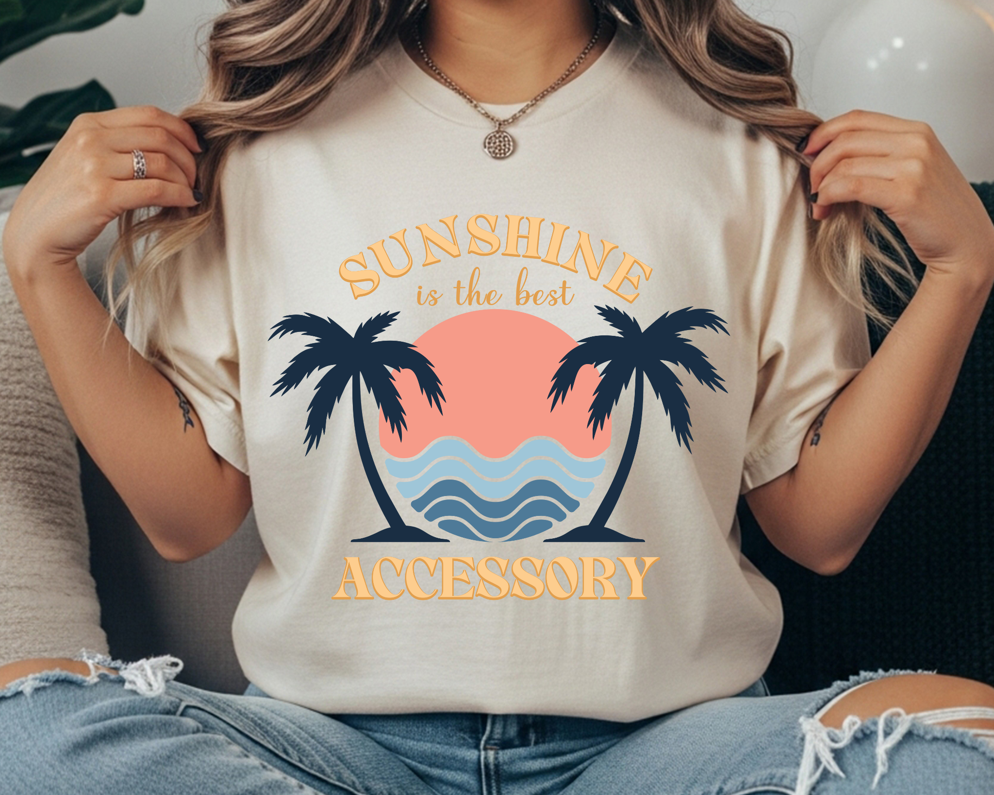 Comfort Colors t-shirt with “Sunshine is the Best Accessory” text and a retro palm tree sunset and wave graphic in navy, coral, and light blue.