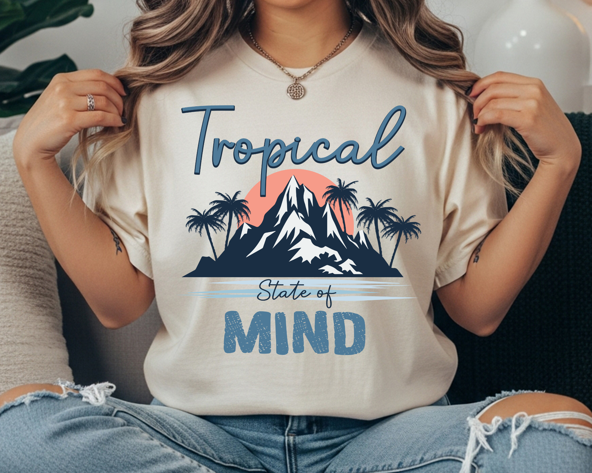 Comfort Colors t-shirt with “Tropical State of Mind” text and a palm tree tropical sunset mountain graphic in blue and coral.