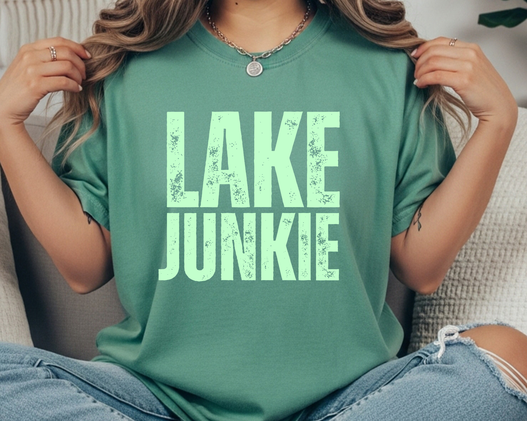 Comfort Colors t-shirt with mint distressed text that reads “LAKE JUNKIE” in large stacked lettering.