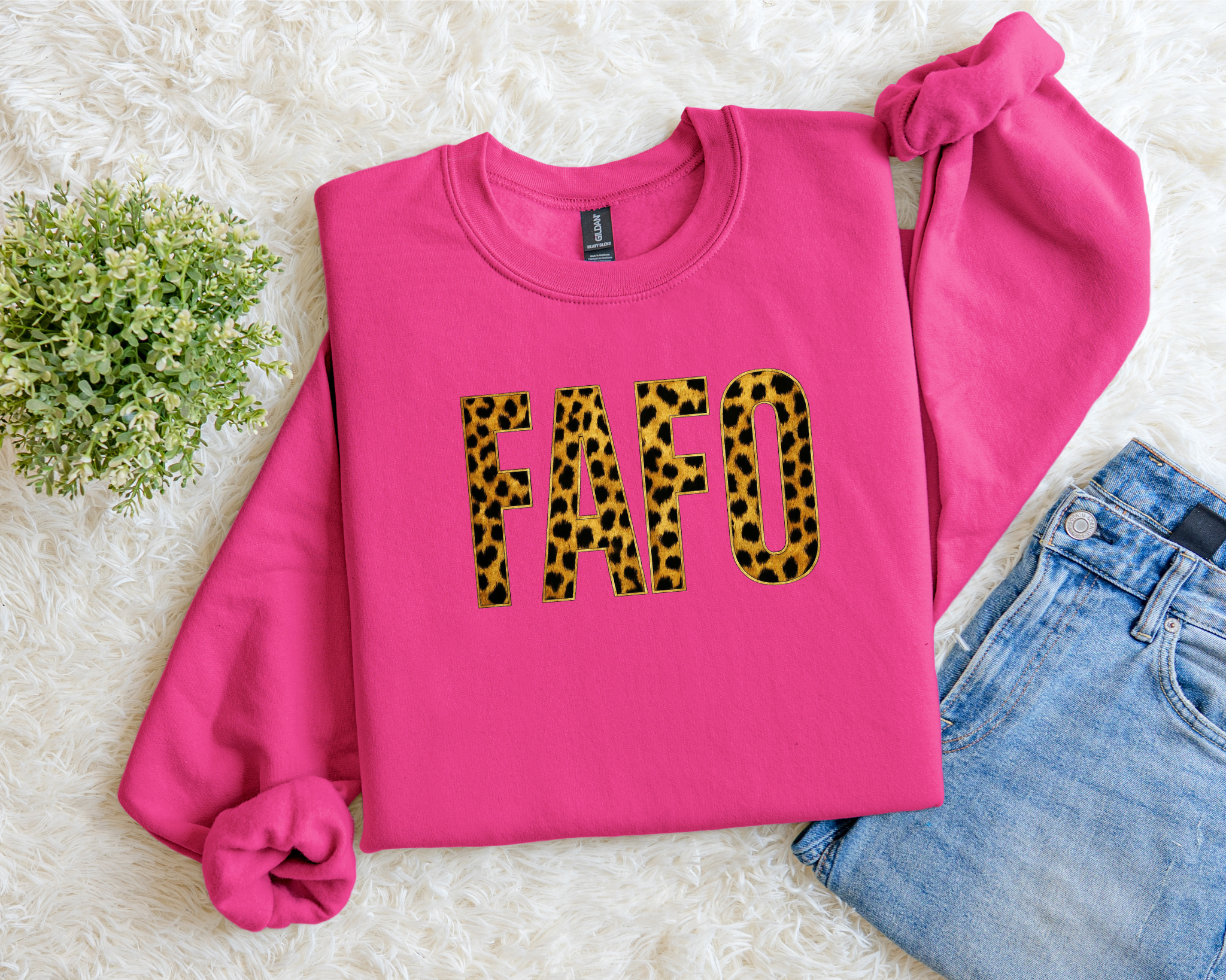 Pink sweatshirt with 'FAFO' in leopard print on a light background
