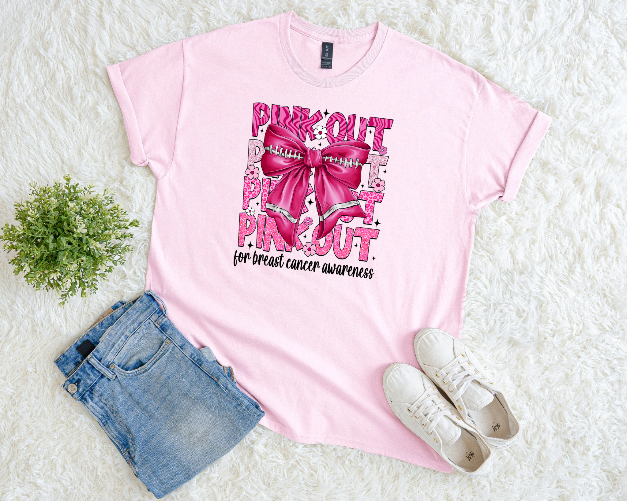 Light pink breast cancer awareness t-shirt with bold “Pink Out” lettering, football bow design, and the phrase “for breast cancer awareness.”