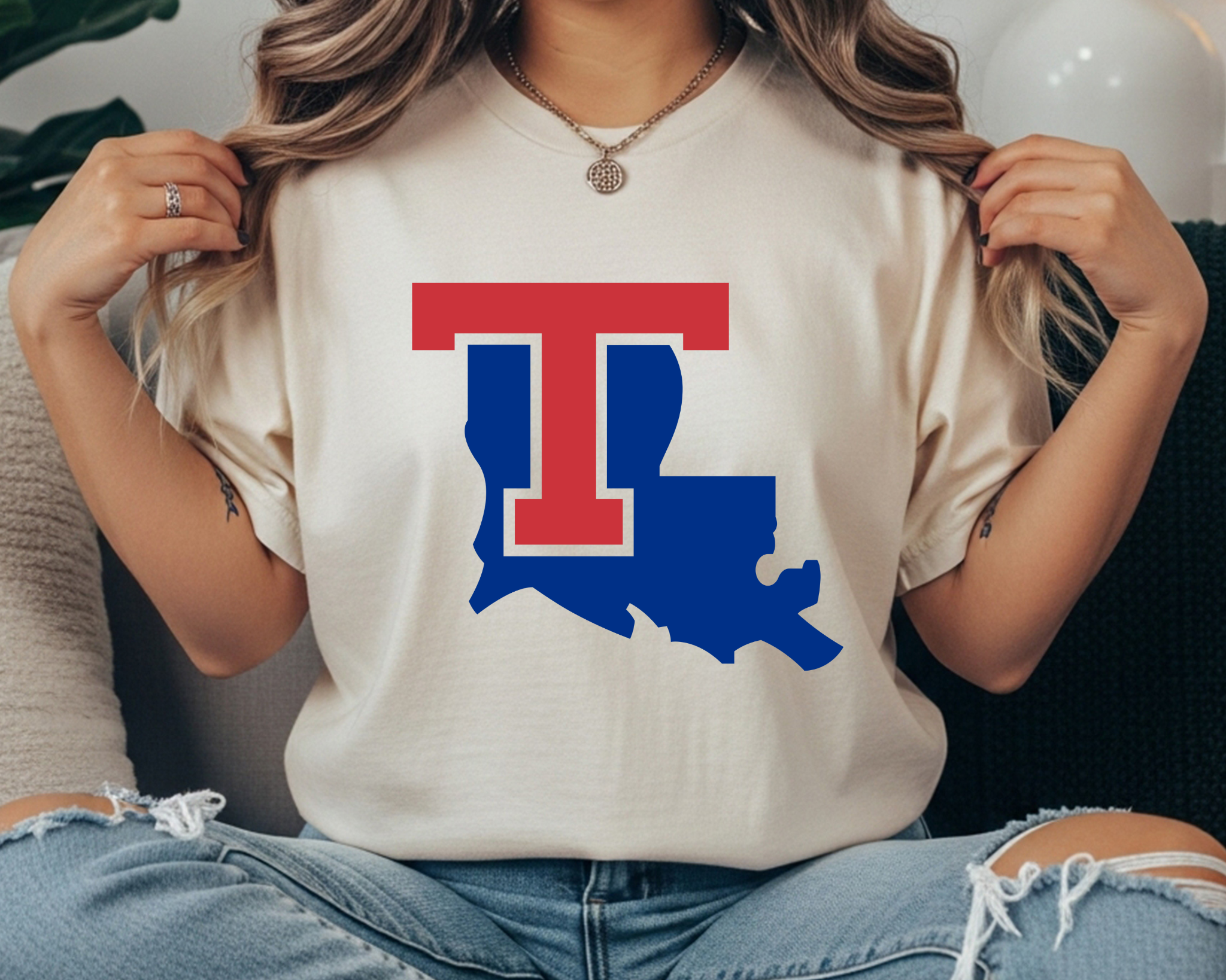 Louisiana Tech Bulldogs Comfort Colors t-shirt featuring a red T logo layered over the blue state of Louisiana on a cream garment-dyed tee.