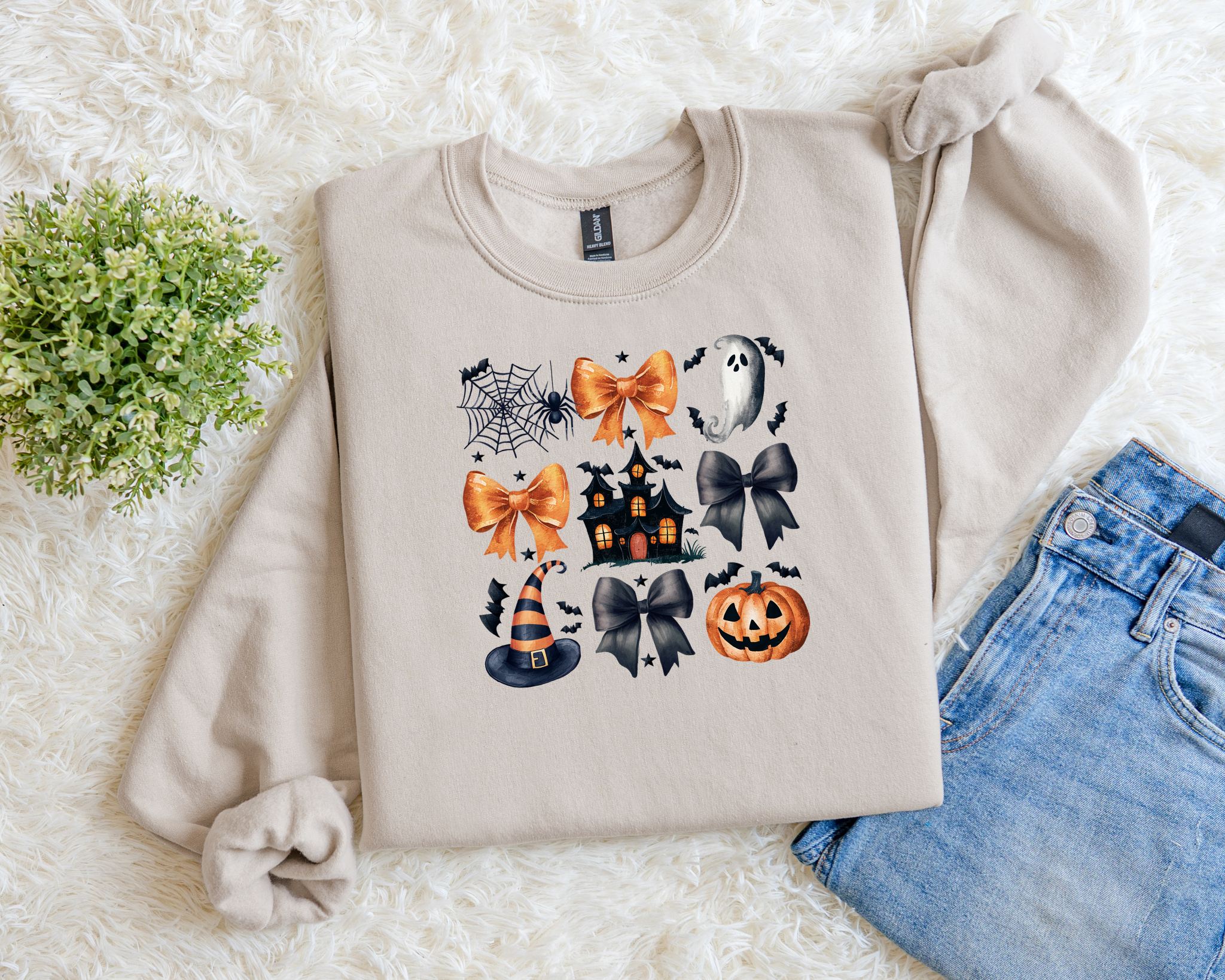 Neutral Halloween sweatshirt with orange and black bows, spiderwebs, ghosts, haunted house, witch hat, and pumpkin graphics.