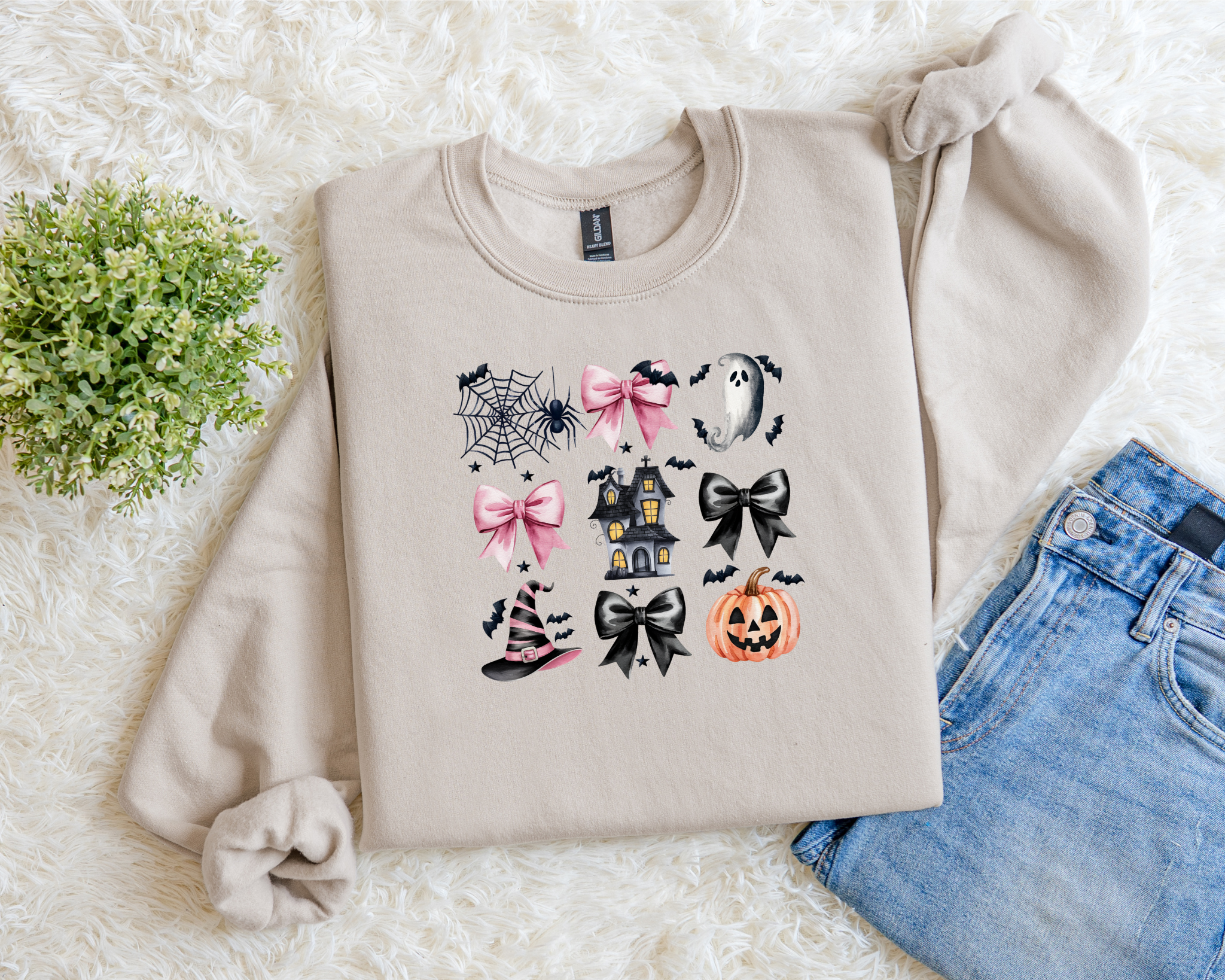 Neutral Halloween sweatshirt with pink and black bows, spiderwebs, ghosts, haunted house, witch hat, and pumpkin graphics.