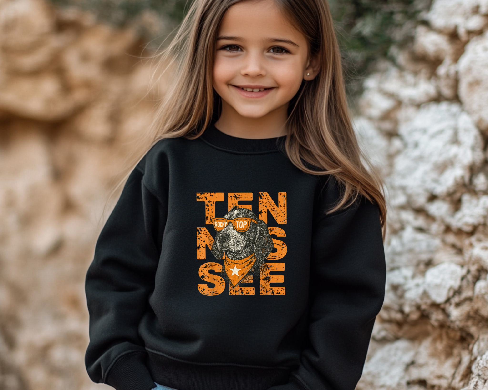 Young girl wearing a black sweatshirt with 'TENNESSEE' and a dog graphic.