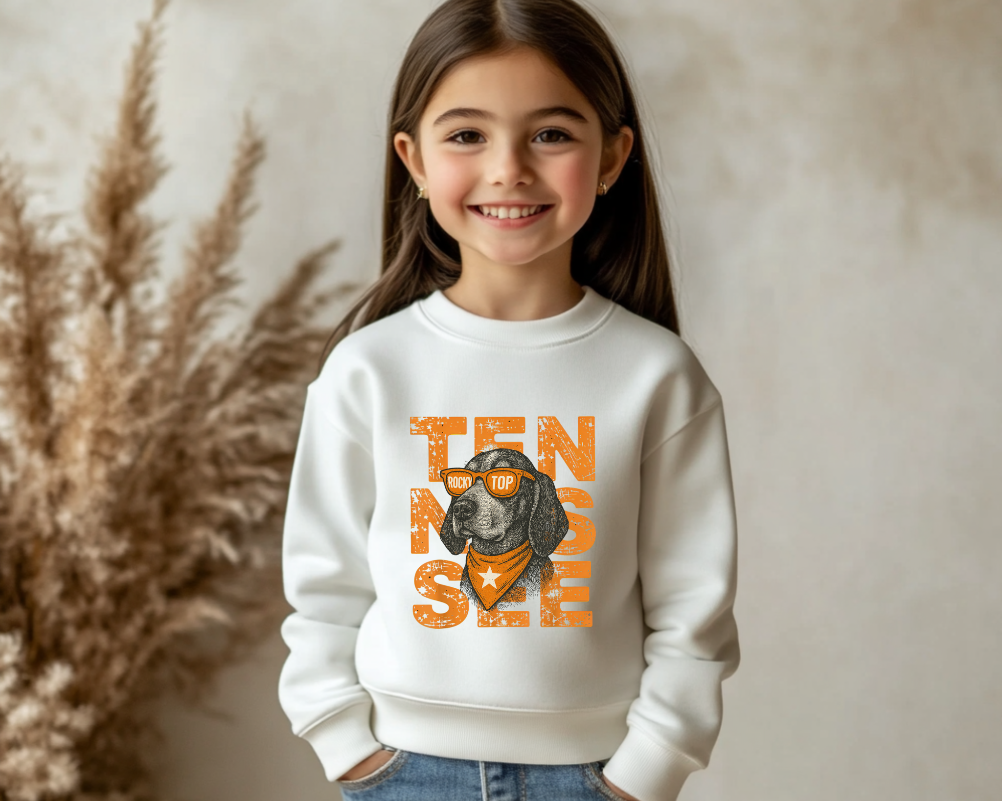 Child wearing a white sweatshirt with a dog graphic and text, standing against a neutral background.