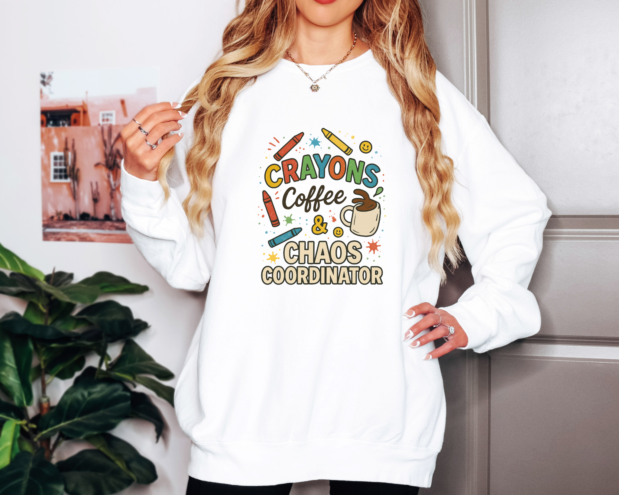 White Comfort Colors crewneck sweatshirt with “Crayons, Coffee & Chaos Coordinator” in colorful text and classroom doodles.