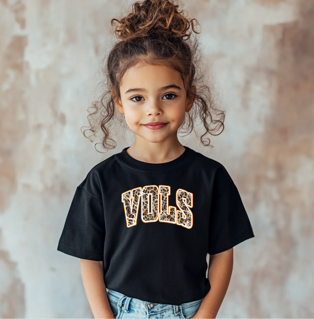 Youth black VOLS t-shirt featuring a bold leopard print and orange outline, Stylish kids’ game-day outfit for Tennessee fans.