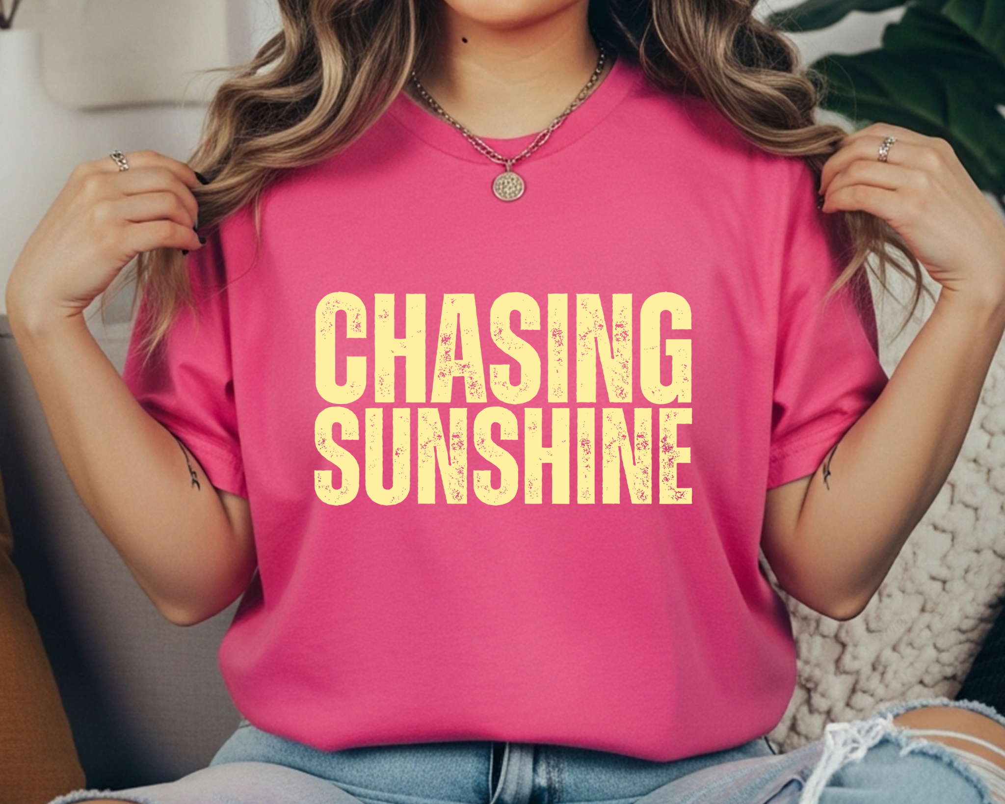 Comfort Colors t-shirt with cream distressed stacked text that reads “CHASING SUNSHINE.”