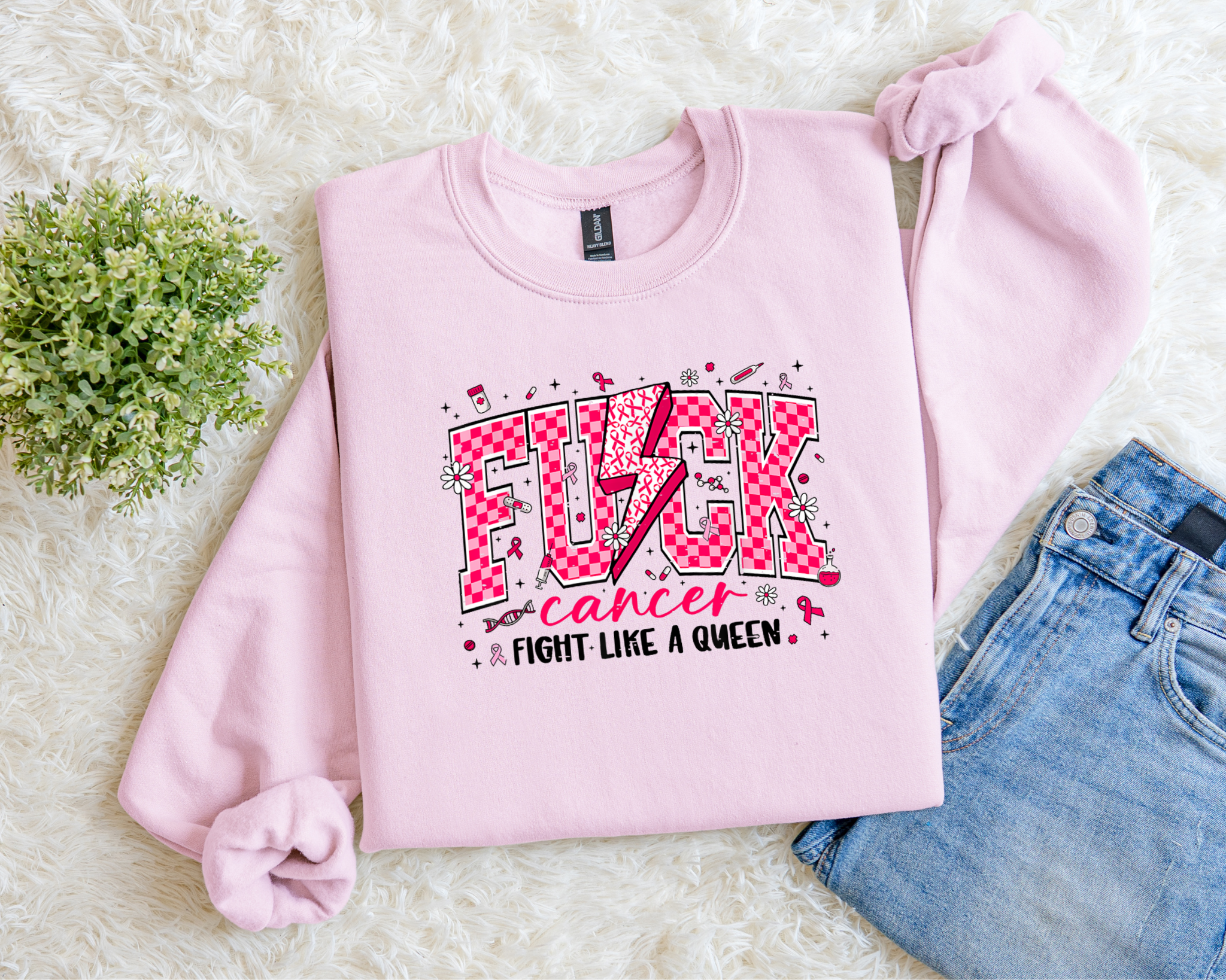 Pink sweatshirt with 'Fight Like a Queen' text on a light background