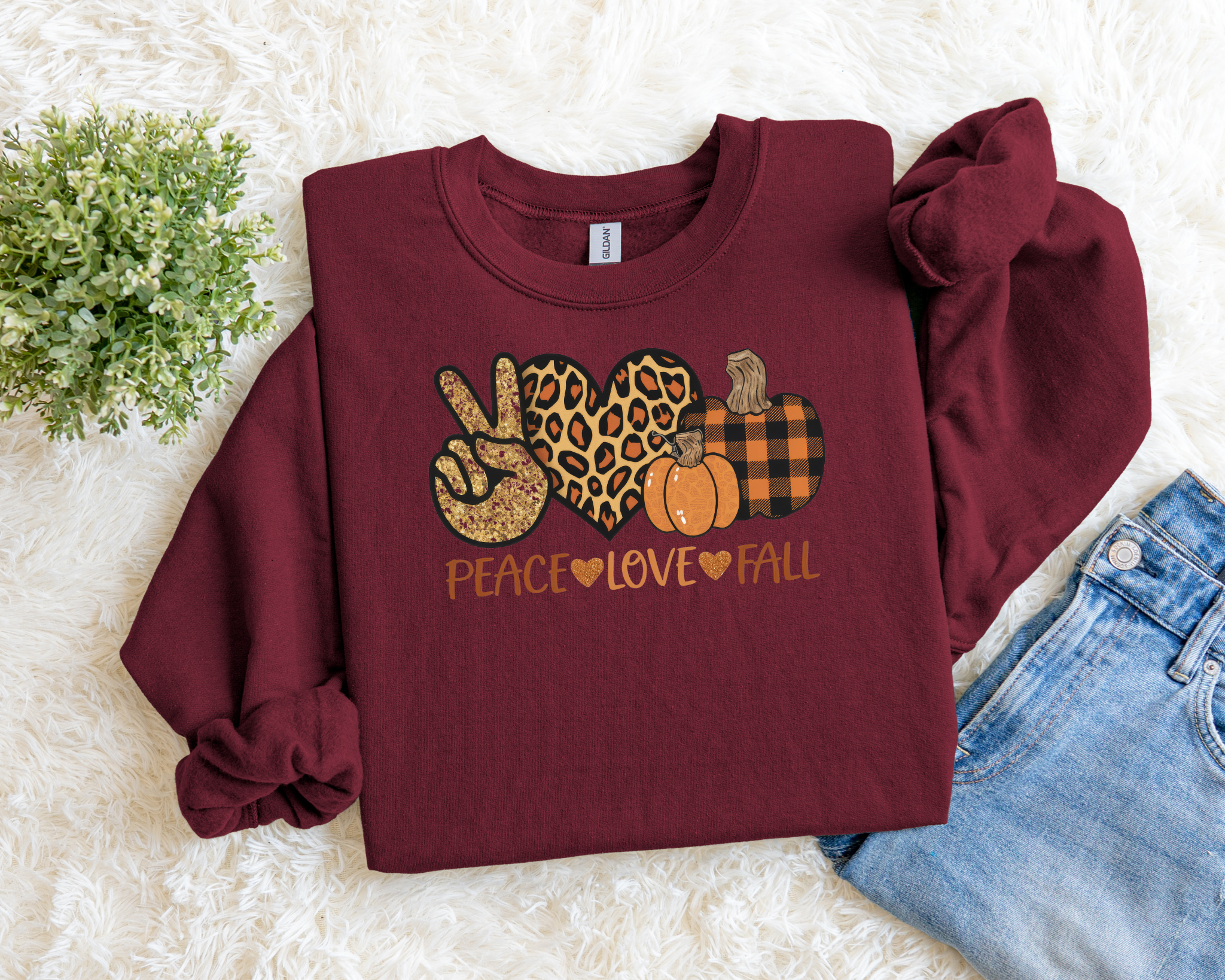 Maroon sweatshirt with 'Peace Love Fall' design on a light background