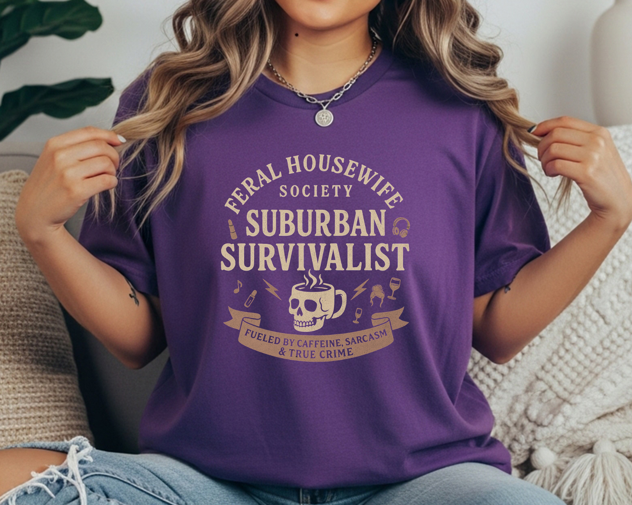 grape Comfort Colors tee with beige print reading “Feral Housewife Society - Suburban Survivalist - Fueled by Caffeine, Sarcasm & True Crime.”