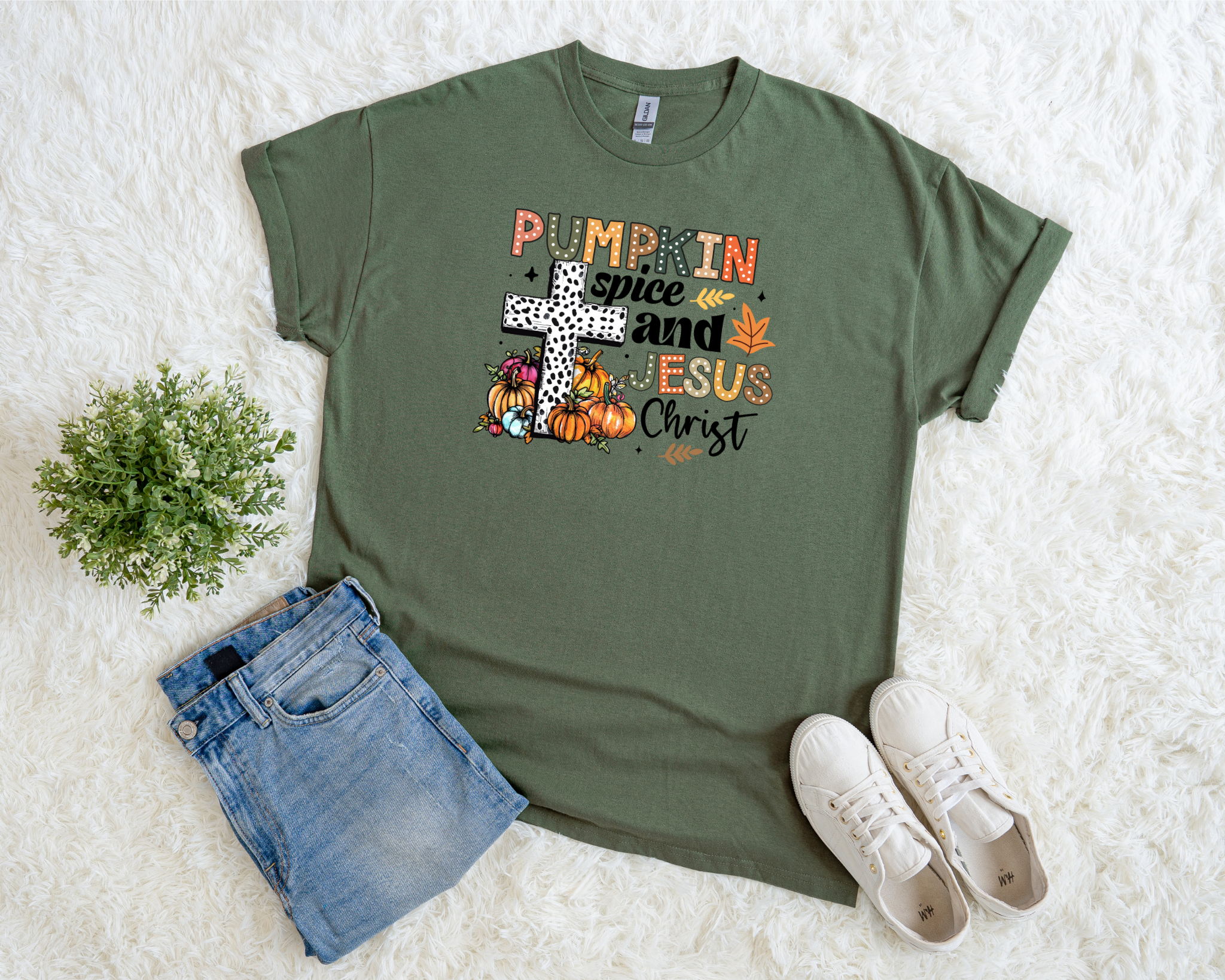 Neutral Christian fall t-shirt with pumpkins, leaves, cross graphic, and the phrase “Pumpkin Spice and Jesus Christ.”