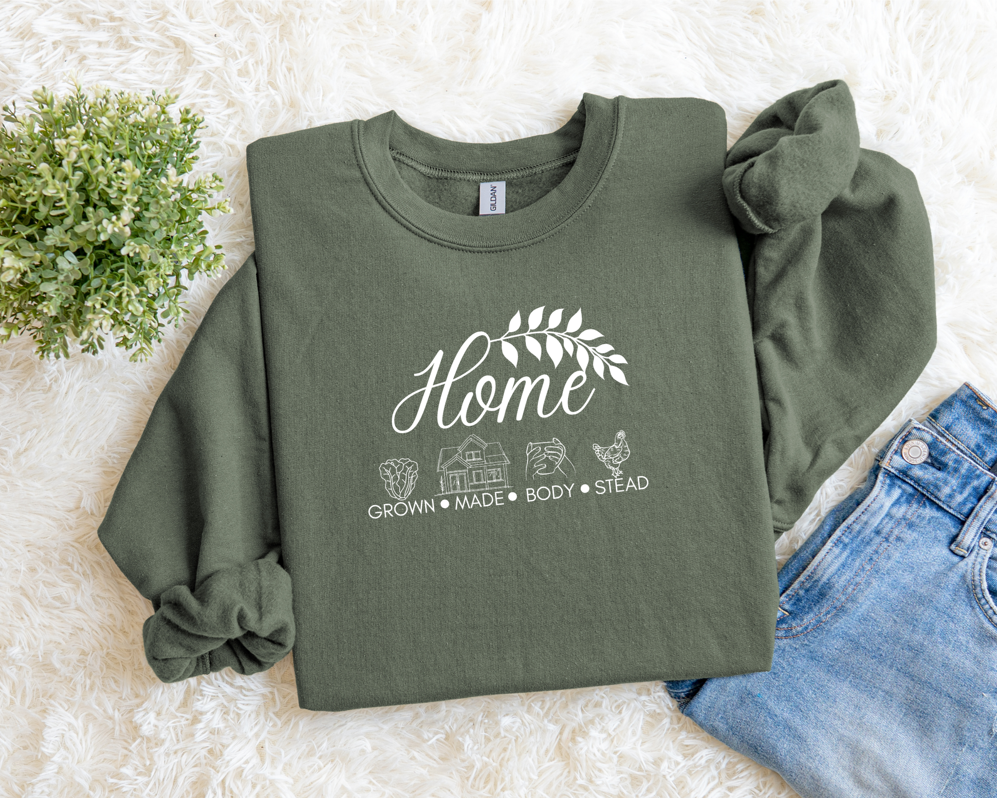 Green sweatshirt with 'Home' text and graphics on a light background
