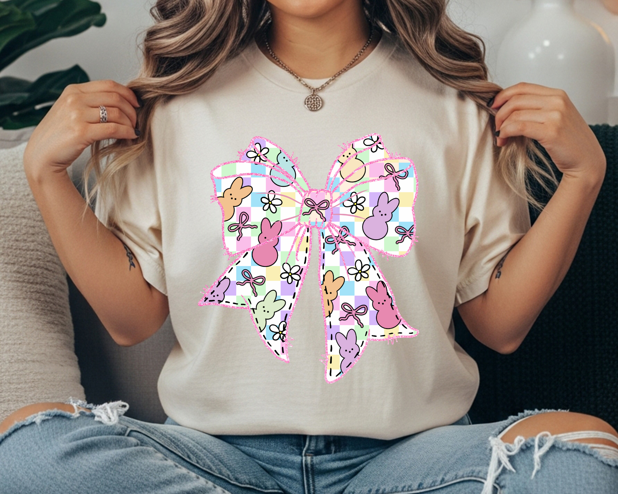 Comfort Colors t-shirt featuring a large pastel Easter bow graphic with bunny silhouettes, floral doodles, and a plaid pattern.