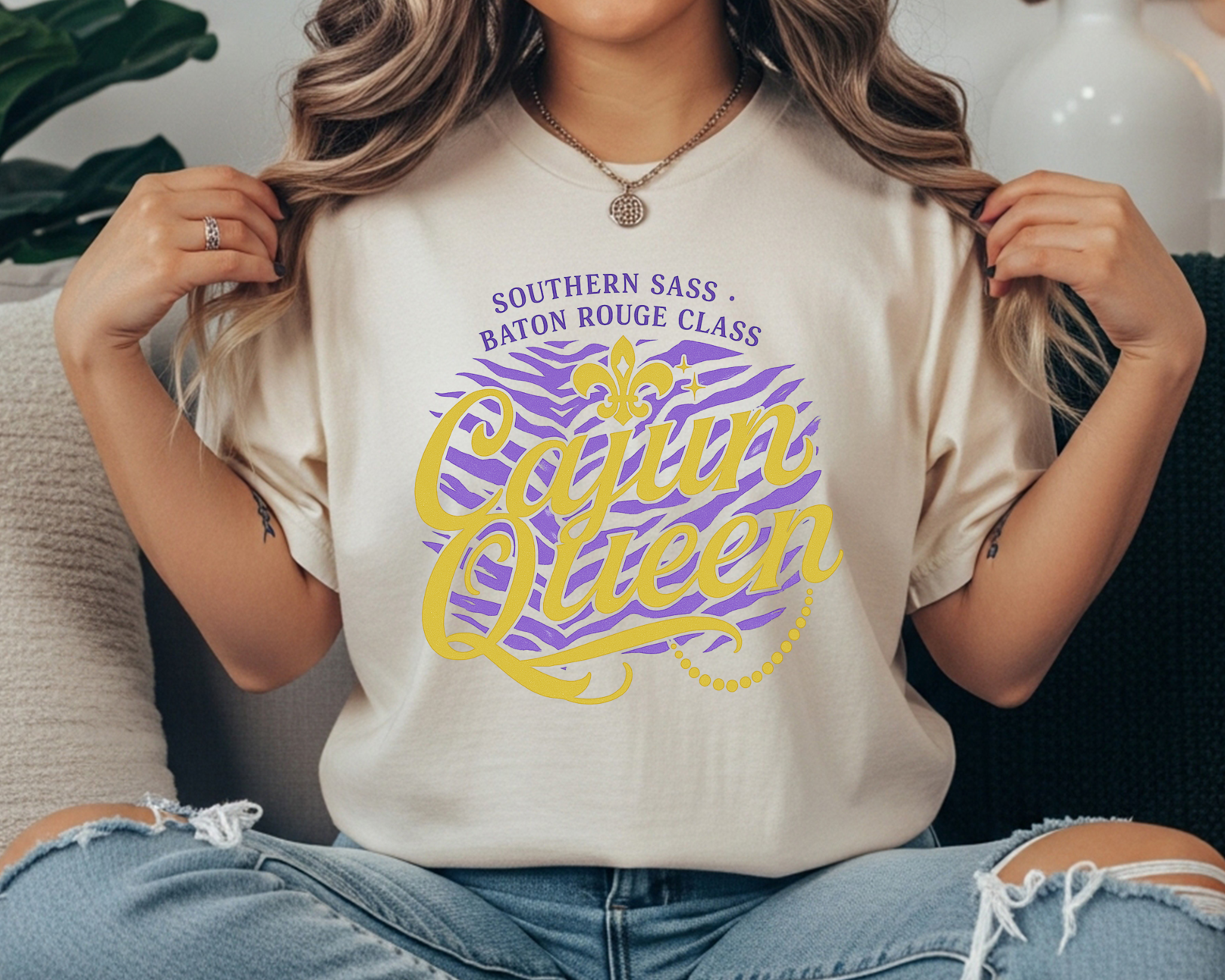 ivory Comfort Colors tee with gold and purple text reading “Cajun Queen – Southern Sass, Baton Rouge Class” with fleur-de-lis and zebra print.