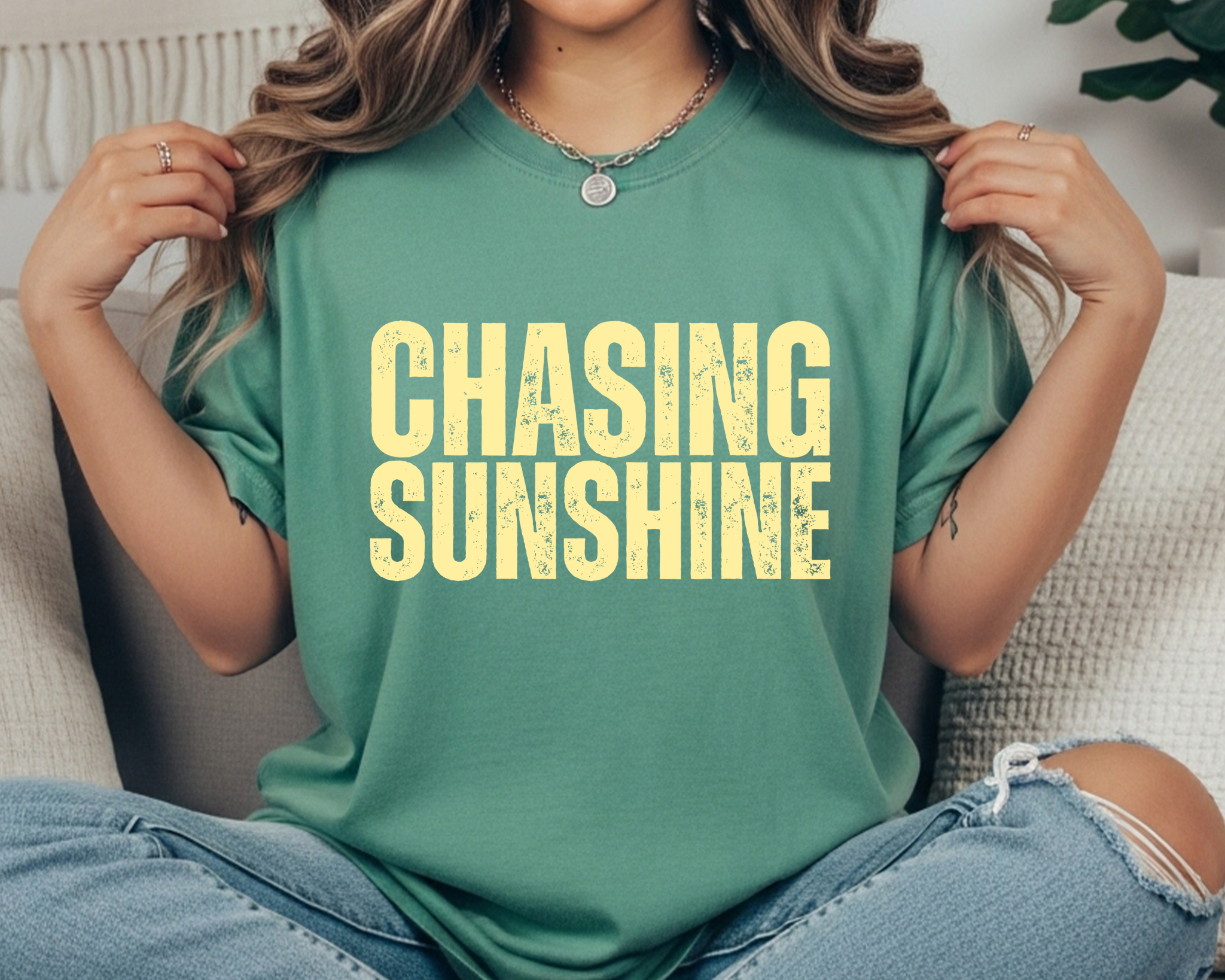Comfort Colors t-shirt with cream distressed stacked text that reads “CHASING SUNSHINE.”