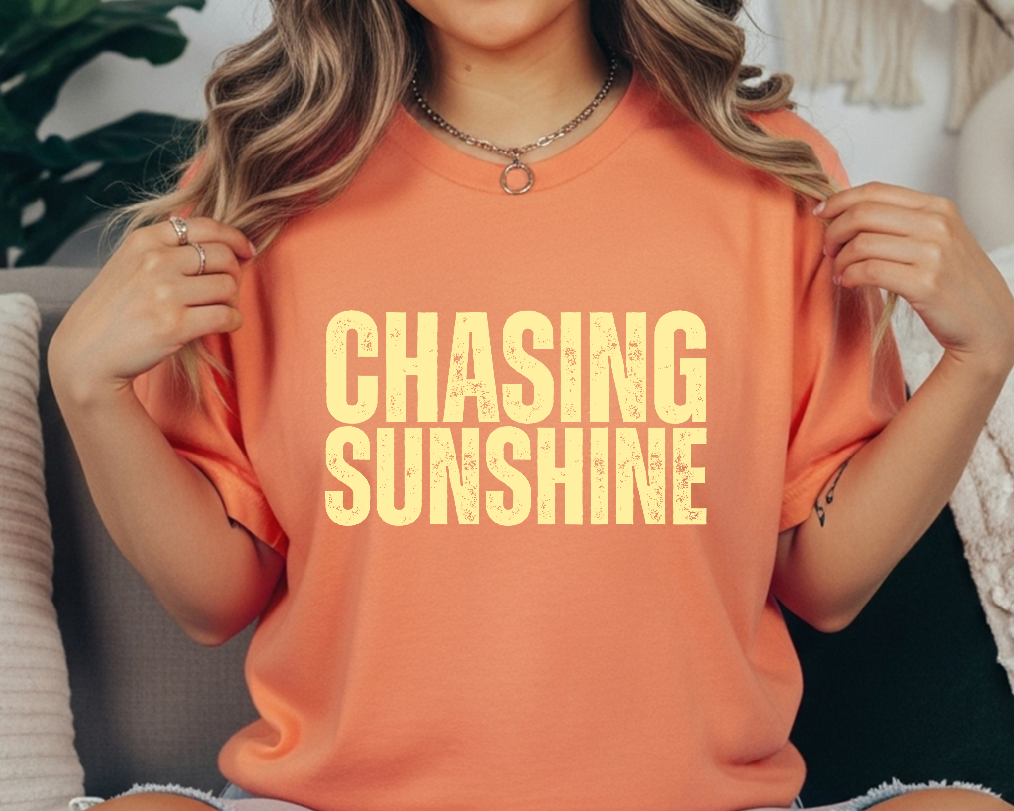 Comfort Colors t-shirt with cream distressed stacked text that reads “CHASING SUNSHINE.”