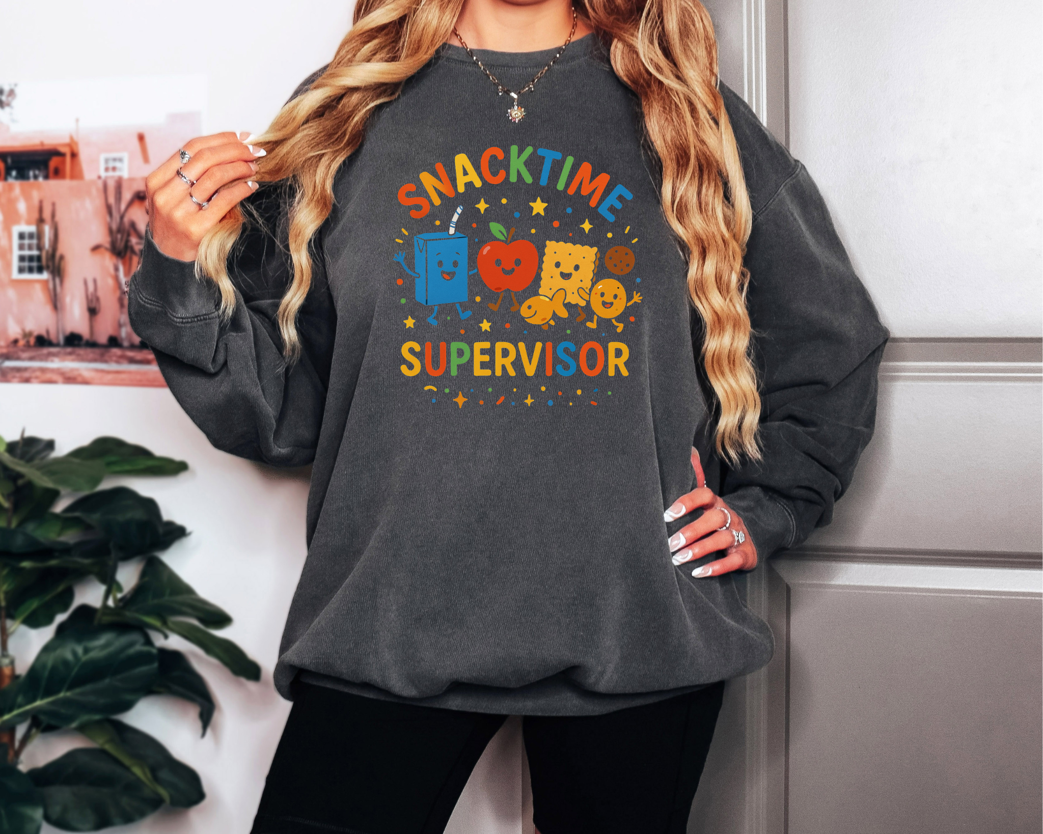 pepper Comfort Colors crewneck sweatshirt with “Snacktime Supervisor” in colorful letters and smiling snack characters.