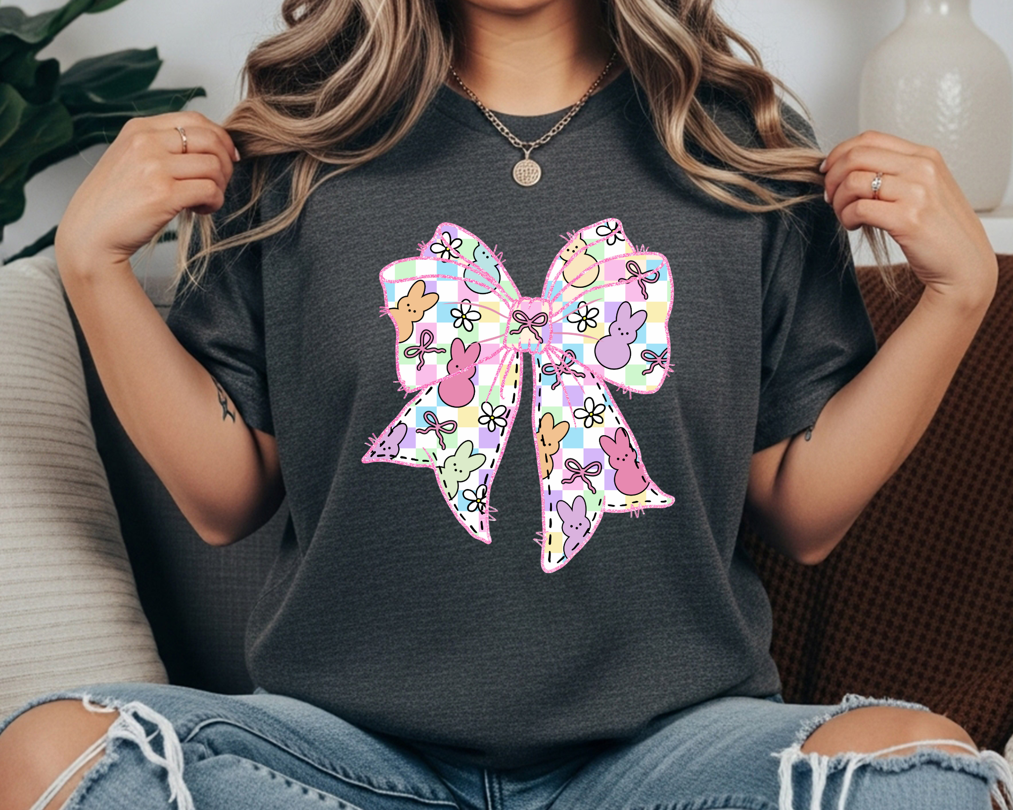 Comfort Colors t-shirt featuring a large pastel Easter bow graphic with bunny silhouettes, floral doodles, and a plaid pattern.