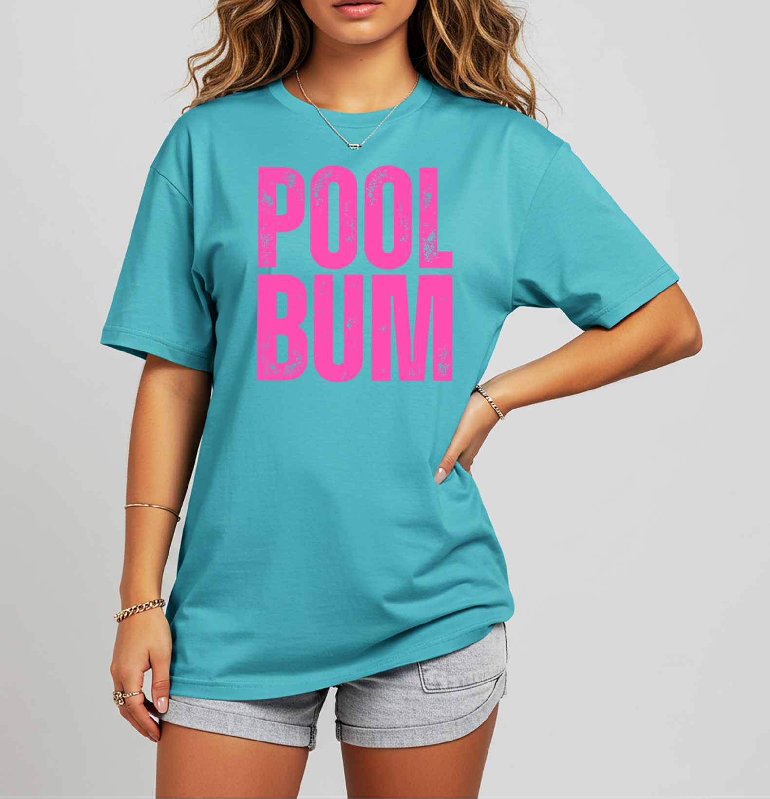 t-shirt with bold pink distressed “POOL BUM” text on the front, styled with denim shorts.
