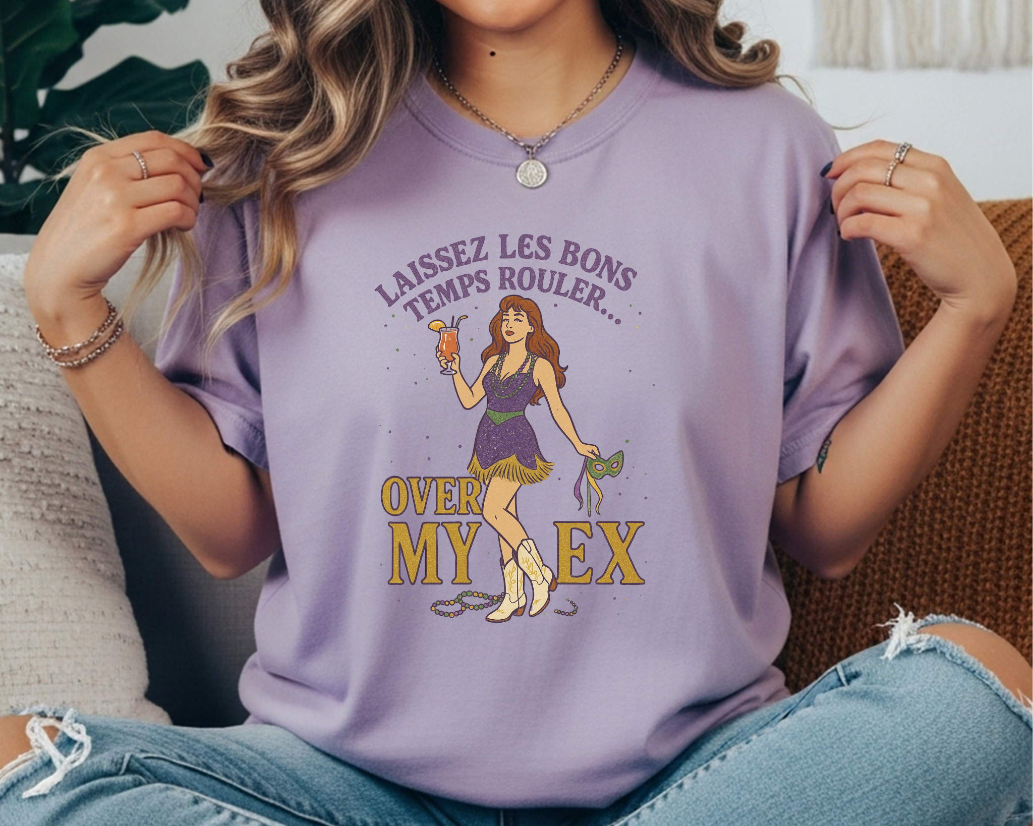 violet Comfort Colors tee featuring Mardi Gras design with cowgirl holding a mask and drink, text reads “Laissez Les Bons Temps Rouler Over My Ex.”